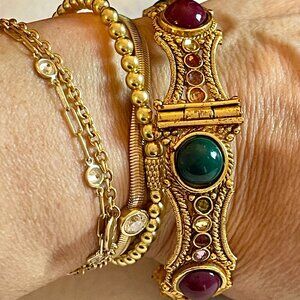 Indian gold-toned hinged bangle with crystals and green/red stones, screw close